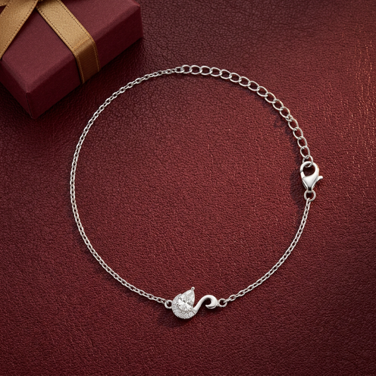 Serene Swan Silver Bracelet flatlay on oxblood leather with a gift box