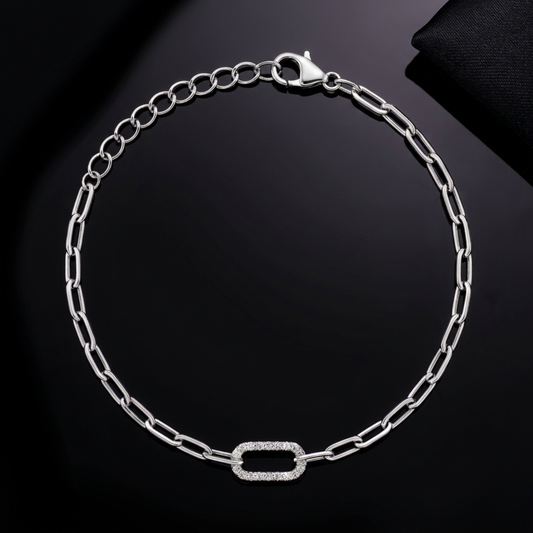 Capsule Link Silver Bracelet flatlay on polished black with violet shimmer